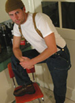 Blue collar man in suspenders, carhartts and cap.